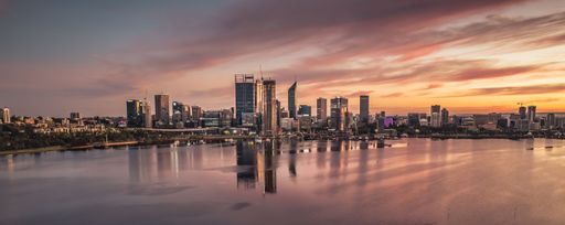 Panoramic view of Perth city skyline at sunset with beautiful reflections on the Swan River, Western Australia