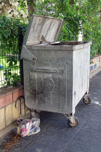 An old trash can on the street