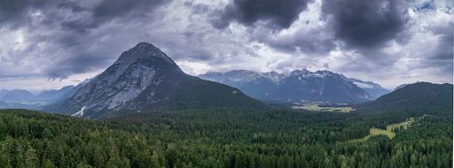 The mountains covered in dense forest in Tirol, Austria on a gloomy day