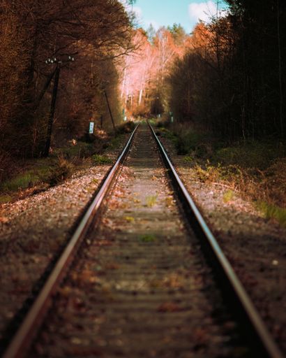 A vertical shot of railway rails in a countryside