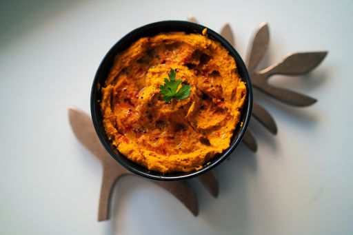 An overhead shot of a delicious bowl of curry on a white table
