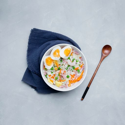 A top view of noodles with vegetables isolated on a white background