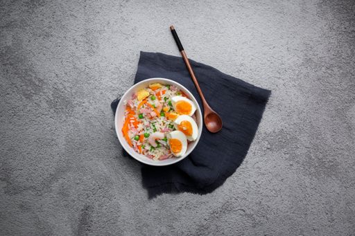 A top view of noodles with vegetables isolated on a white background