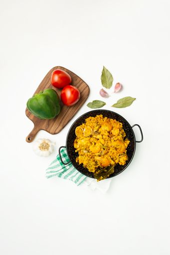 A top view of paella with seafood with ingredients isolated on a white background