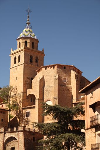 A beautiful view of the cathedral in Albarracin, Spain, with its iconic bell tower under a clear blue sky.
