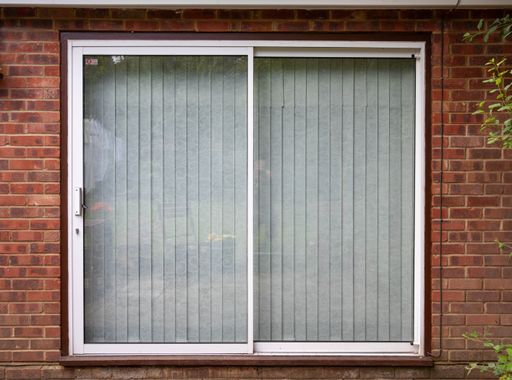 A closeup shot of a closed window on a brick wall background