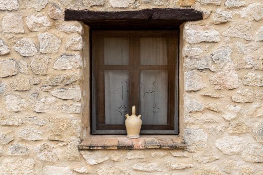 A closed window on a stone building