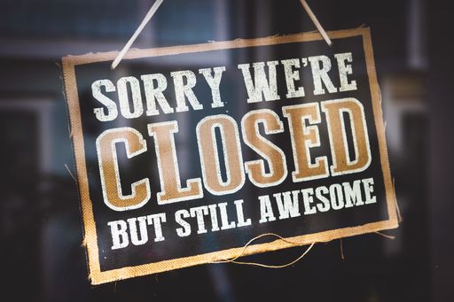 A closeup shot of a sign that says "Sorry we're closed but still awesome"