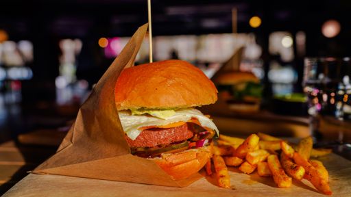 An appetizing burger with french fries