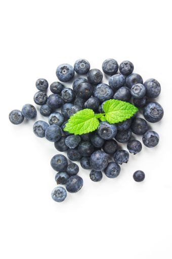 A top view of blueberries with mint isolated on a white background