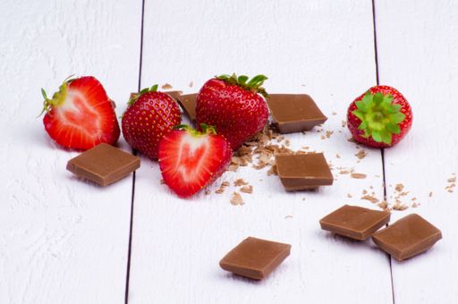 A closeup of chocolate and strawberries on a white table