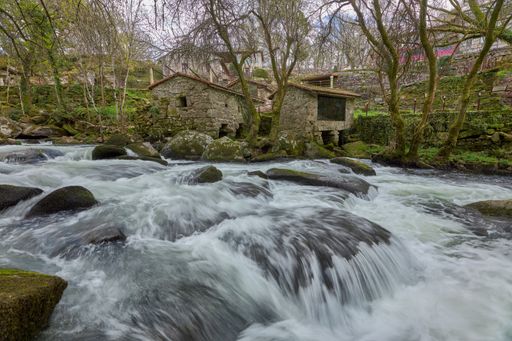 Old restored traditional houses on the banks of the Arenteiro river in the area of Galicia, Spain