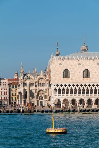 A scenic view of architectural buildings and a port in Venice, Italy