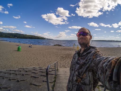 A male taking a selfie by the beach with a beautiful morning view