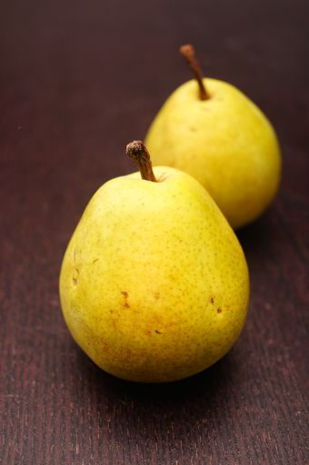 A vertical shot of two pears next to each other