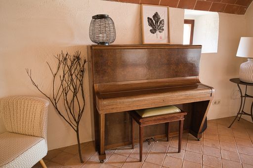 A vintage brown piano in a well-decorated house