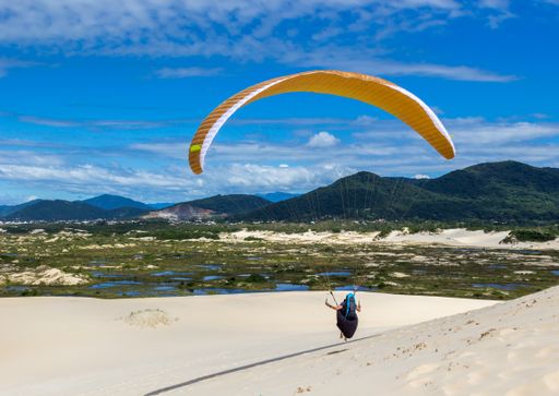 A shot of paragliding in the Dunes near Joaquina Beach Florianopolis Brazil