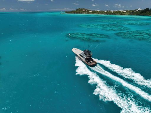 An aerial view of a boat riding to an island in Bermuda