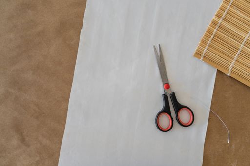 A top view of the working area for making a scrapbook with scissors and white clean paper