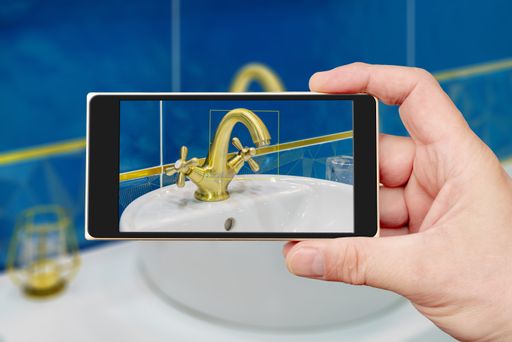 A water tap on a smartphone screen. Water tap and sink in the bathroom. The interior of the living quarters