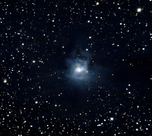 A stunning view of a star-filled night sky with a bright iris nebula in the center.
