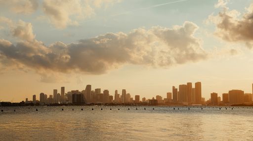 A high angle shot of cityscape with high buildings with a wide river stream in the foreground