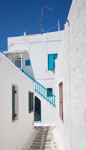 A vertical shot of traditional whitewashed buildings of Mykonos in Greece