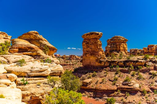 A scenic view of rock formations in Arches National Park under a clear blue sky
