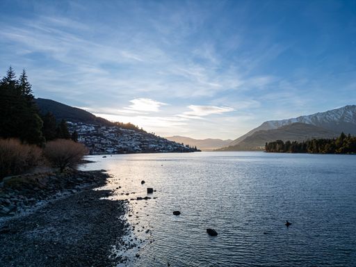 Scenic view of Queenstown, New Zealand with mountains and lake Wakatipu at sunset