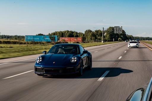 Porsches driving on the highway through Orlando, FL