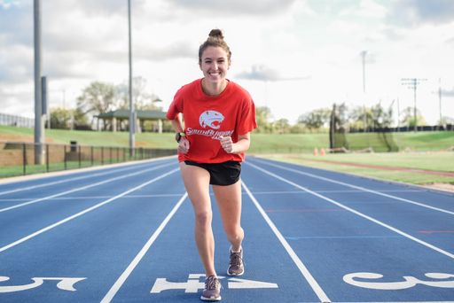 A selective of a happy girl running on a track