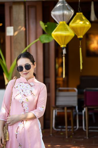 A vertical shot of a fashionable Asian woman in a street in Thailand