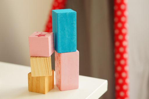 Several multicolored rectangular toys for children on top of each other