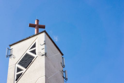 A low angle shot of a white chimney under a blue sky