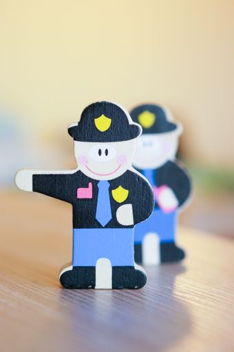 A vertical shot of wooden policemen toy on a table