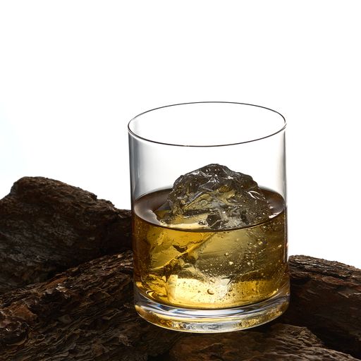 A vertical shot of a glass of iced whiskey on a rock