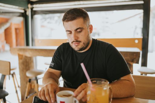 A young Bosnian male having drinks at the cafe