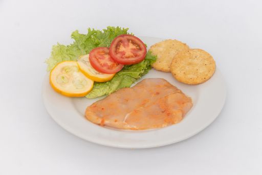 A high angle shot of a piece of chicken meat and vegetables on a plate on an isolated background