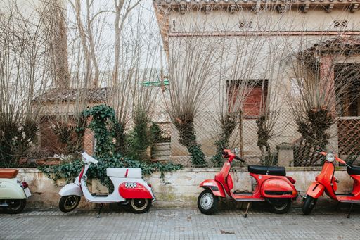 A wide shot of white and red motorcycles assorted in a row