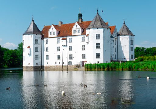 A scenic view of the Glucksburg Castle in Germany under a clear sky