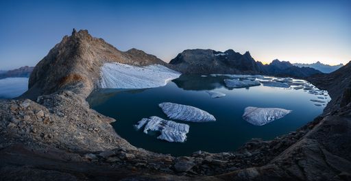 Summer landscape view of the Chuebodengletscher with icebergs on a glacier lake at blue hour in Gerenpass Val Bedretto
