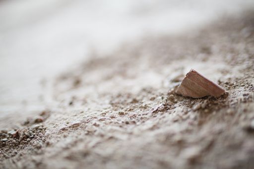A closeup shot of a stone rubbles on a sandy surface