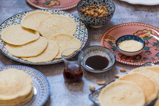 A high angle shot of desserts in eastern decorated and painted plates