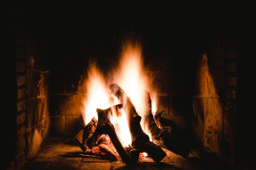 A unique shot of an indoor flamy fireplace