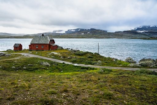 An isolated house on a lake in the Hardangervidda National Park near Finse, Norway