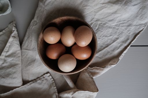 A bowl of fresh chicken eggs on the kitchen table