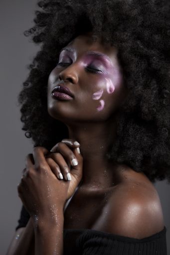 A portrait of an attractive African-American female with beautiful makeup posing with her eyes closed