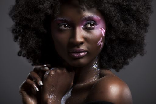 A portrait of an attractive African-American female with beautiful makeup and dark hair