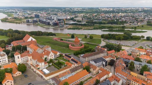 An aerial view of Kaunas Castle and the cityscape along the Neris River in Kaunas, Lithuania