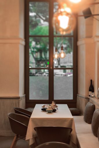 A vertical shot of a romantic table arrangement at a restaurant near a window